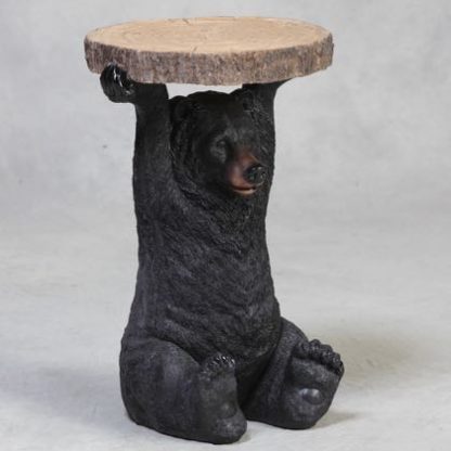 black bear side table has a bear holding a slice of tree trunk above his head that is the surface of the table. Measures 52 x 36 x 36cm