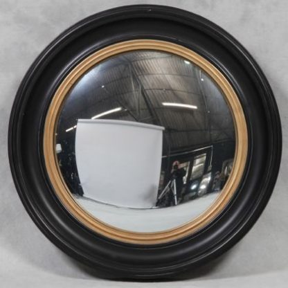 Damaged large black convex mirror is a huge round mirror that has a black and gold painted wooden frame and a convex mirror