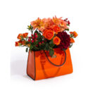 Add a glamorous vibe to your home with this bright orange handbag vase. Made of ceramic, super glossy finish 16 x 14 x 24cm. Works as a utensil holder too!