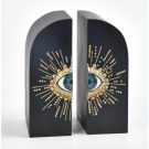 This super embossed sunburst eye bookends are matt black rounded blocks with a central blue eye and embossed gold eyelashes radiating out 11 x 13 x 18cm
